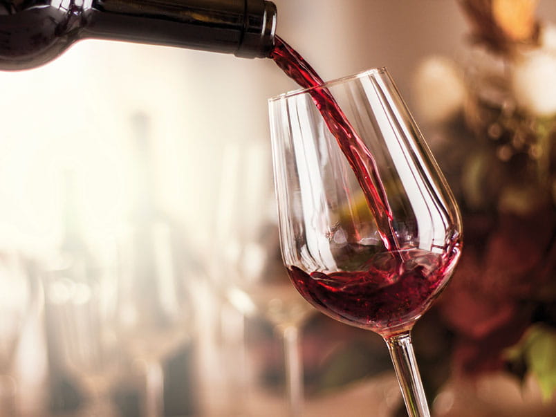 Red wine being poured in to a glass